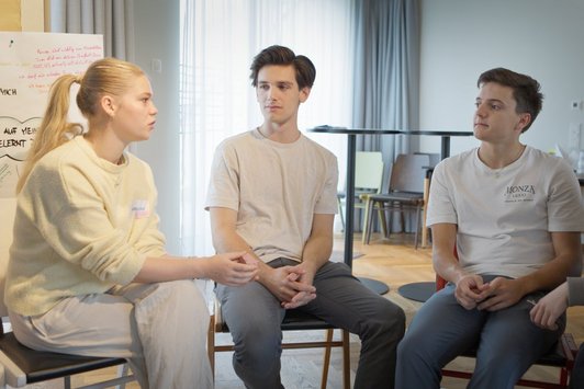 Drei junge Menschen interagieren 