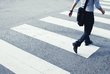  A man walks across a zebra crossing.