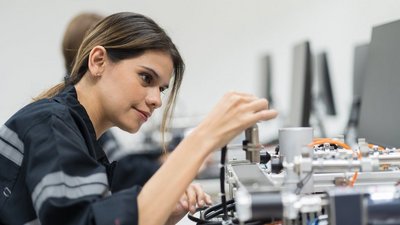 Female engineer training AI robot training kit and mechatronics engineering in the manufacturing automation and robotics academy roomFemale engineer training AI robot training kit and mechatronics engineering in the manufacturing automation and robotics academy room