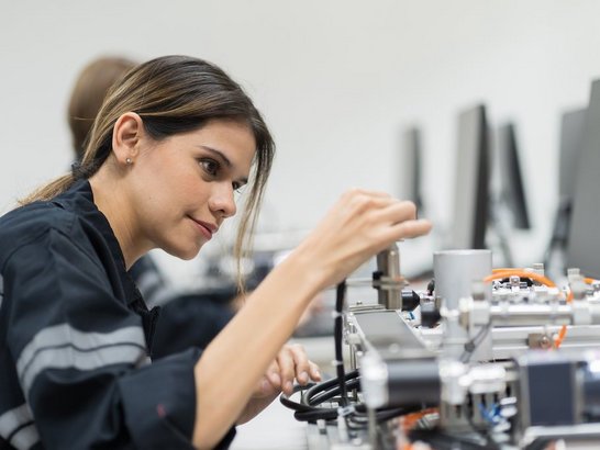 Female engineer training AI robot training kit and mechatronics engineering in the manufacturing automation and robotics academy roomFemale engineer training AI robot training kit and mechatronics engineering in the manufacturing automation and robotics academy room