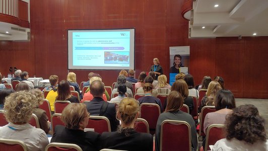 A woman holds a presentation in front of the audience