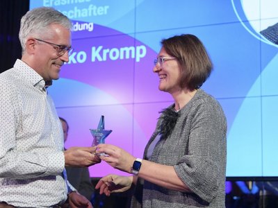 Frau gratuliert Mann und überreicht einen Award in Sternform