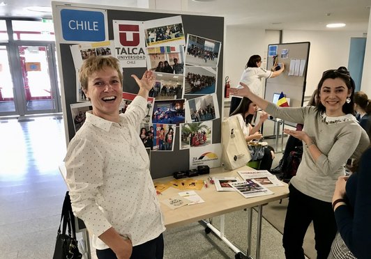 Mitarbeiterinnen präsentieren stolz ihren Stand bei einer Messe