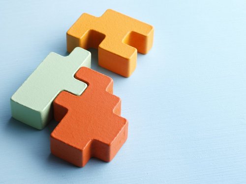 Drei bunte Puzzlesteine, die ineinander passen