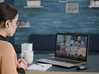 University student attending video call meeting with people on online school class, using laptop at home. Woman having conversation on remote teleconference, webinar learning chat.